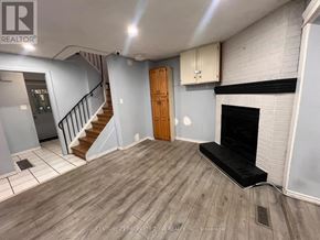 Brampton (Brampton South) apartment for rent - A room with a wooden floor, a staircase, and a fireplace.