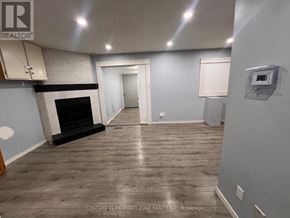 Brampton (Brampton South) apartment for rent - A spacious room with a fireplace and wooden flooring.