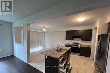 Niagara Falls (Brown) apartment for rent - A kitchen with a refrigerator, sink, and stove.