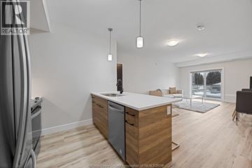 Kingsville condo for rent - A modern kitchen with wooden cabinets and a white countertop.