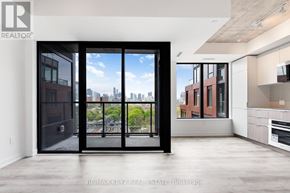 Toronto (Moss Park) condo for rent - A modern room with a view of the city through large windows.