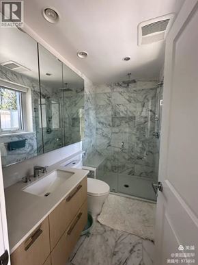 Vancouver apartment for rent - A bathroom with marble tiles and a walk-in shower.