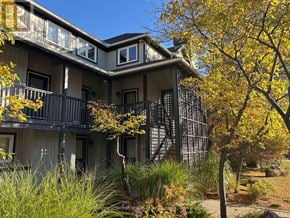 Collingwood townhouse for rent - A building with a balcony and trees in front of it.