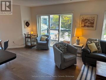 Collingwood townhouse for rent - A living room with a grey chair and a black couch.
