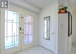 Mississauga (Lisgar) apartment for rent - A white door with a mirror above it.