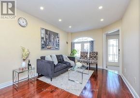 Mississauga (Lisgar) apartment for rent - A living room with a grey couch, a glass coffee table, and a painting on the wall.
