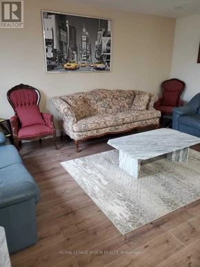 Fort Erie (Central) duplex for rent - A living room with a couch, two chairs, and a coffee table.