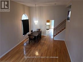 London North (North B) house for rent - A room with a wooden floor and a dining table with chairs.