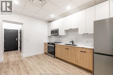 Chatham apartment for rent - A kitchen with wooden cabinets and a black refrigerator.