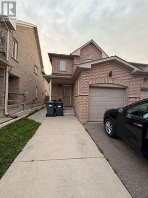 Brampton (Fletcher's Meadow) apartment for rent - A black car is parked on a driveway in front of a house.