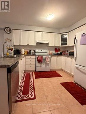 Brampton (Fletcher's Meadow) apartment for rent - A kitchen with white cabinets and a white fridge.