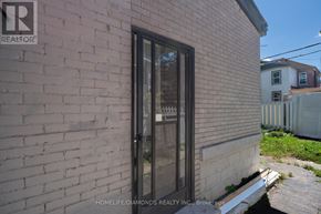 Hamilton (Gibson) apartment for rent - A brick wall with a glass door and a sign that says REALTOR.