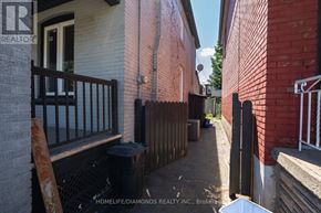 Hamilton (Gibson) apartment for rent - A narrow alley with a trash can and a sign for HomeLife/Diamonds Realty Inc.