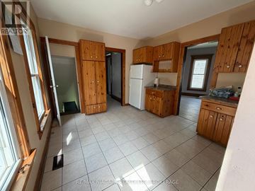 Niagara Falls (Downtown) apartment for rent - A kitchen with wooden cabinets and a white refrigerator.