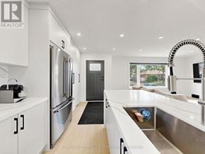 Toronto (Clanton Park) apartment for rent - A modern kitchen with white cabinets and stainless steel appliances.
