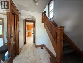 Niagara Falls apartment for rent - A hallway with a staircase and a door on the left.