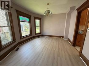 Niagara Falls apartment for rent - A room with wooden floors and a chandelier.
