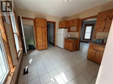 Niagara Falls apartment for rent - A kitchen with wooden cabinets and a white refrigerator.