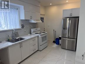 Port Colborne (East Village) multi-family for rent - A kitchen with white cabinets and appliances.
