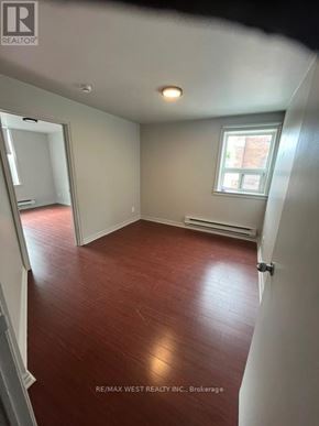 Toronto (Trinity-Bellwoods) apartment for rent - A room with a window and a wooden floor.