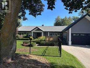 Meaford apartment for rent - A house with a black fence in front of it.