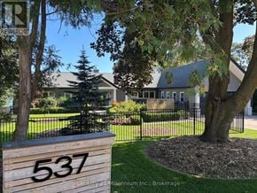 Meaford apartment for rent - A sign with the number 537 on it in front of a house.