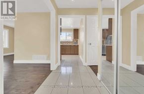 Brampton (Madoc) apartment for rent - A spacious room with beige walls and a wooden floor.