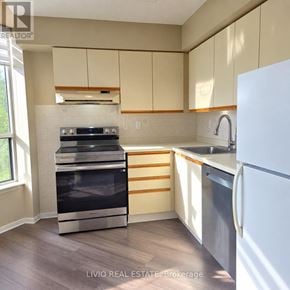 Brampton (Queen Street Corridor) condo for rent - A kitchen with a white fridge, stove and oven.