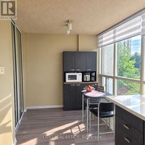 Brampton (Queen Street Corridor) condo for rent - A kitchen with a microwave on the cabinet.