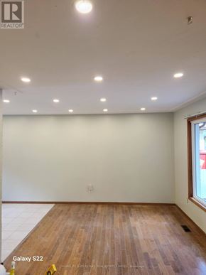 Waterloo apartment for rent - A room with wooden flooring and white walls, with a window on the right side.