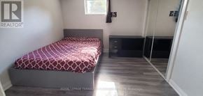Brampton (Westgate) apartment for rent - A bedroom with a bed, dresser, and mirror.