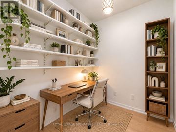 Toronto (Niagara) condo for rent - A room with a desk, chair, and shelves with plants and books.