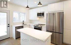 Toronto (Palmerston-Little Italy) apartment for rent - A kitchen with a refrigerator, sink, and stove.