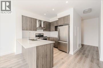 Cambridge condo for rent - A modern kitchen with a white countertop and stainless steel appliances.