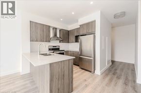 Cambridge condo for rent - A modern kitchen with a white countertop and stainless steel appliances.