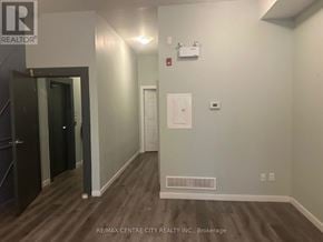 London East (East K) multi-family for rent - A hallway with a door on the left and a white door on the right.