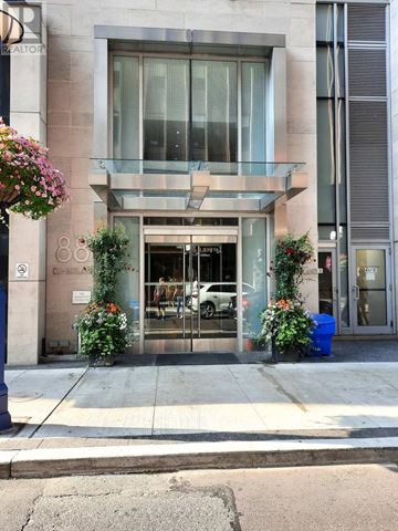 Toronto (Annex) condo for rent - A building with a glass entrance and a sign that says "REALTOR".