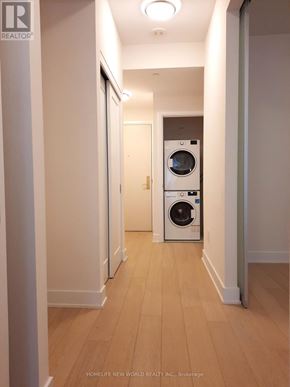 Toronto (Annex) condo for rent - A hallway with a washer and dryer in it.