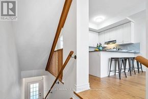 Oshawa (Windfields) townhouse for rent - A realtor photo of a home interior with a bar and stairs.