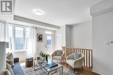 Oshawa (Windfields) townhouse for rent - A living room with a glass coffee table and two chairs.