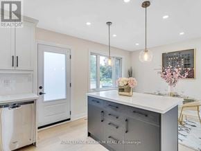 Brampton (Bram East) apartment for rent - A modern kitchen with a large island and a dishwasher.