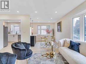 Brampton (Bram East) apartment for rent - A living room with a white sofa, a black chair, and a coffee table.