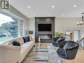 Brampton (Bram East) apartment for rent - A living room with a white couch, a black chair, and a glass coffee table.
