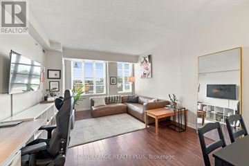 Toronto (Long Branch) condo for rent - A living room with a brown couch and a wooden coffee table.