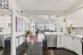 Toronto (Long Branch) condo for rent - A modern kitchen with white cabinets and stainless steel appliances.