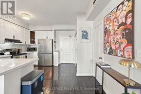 Toronto (Long Branch) condo for rent - A kitchen with white cabinets and a blue trash can.