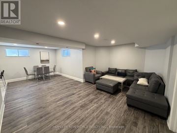 Richmond Hill (South Richvale) apartment for rent - A living room with a grey couch and a wooden floor.