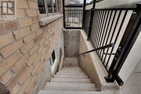 Brampton (Northwest Brampton) apartment for rent - A staircase with a black railing and a brick wall.