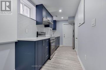 Brampton (Northwest Brampton) apartment for rent - A kitchen with dark blue cabinets and white appliances.