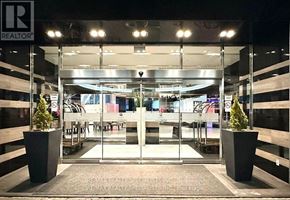 Toronto (Victoria Village) condo for rent - The entrance to a RE/MAX Realty office at night.